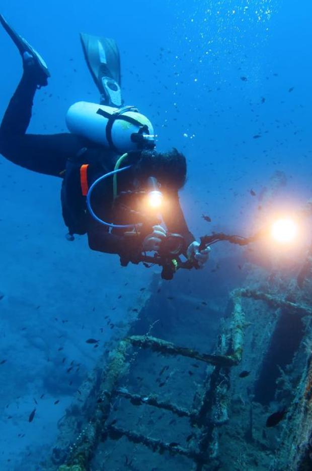 Водолаз се гмурка под водата в търсене на останки от кораб.